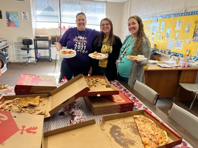 Staff with donated pizza