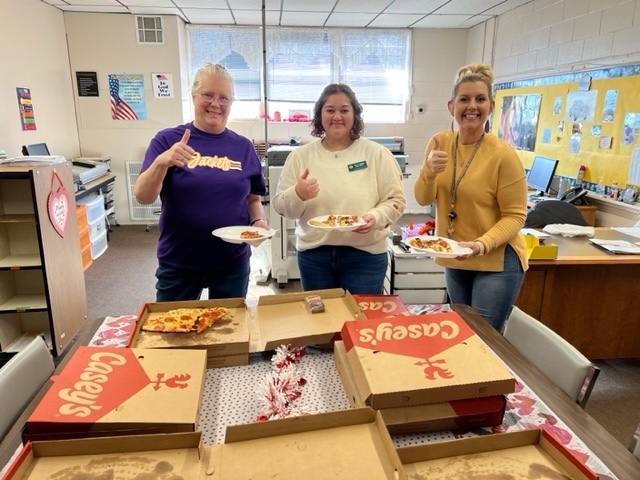 Staff with donated pizza